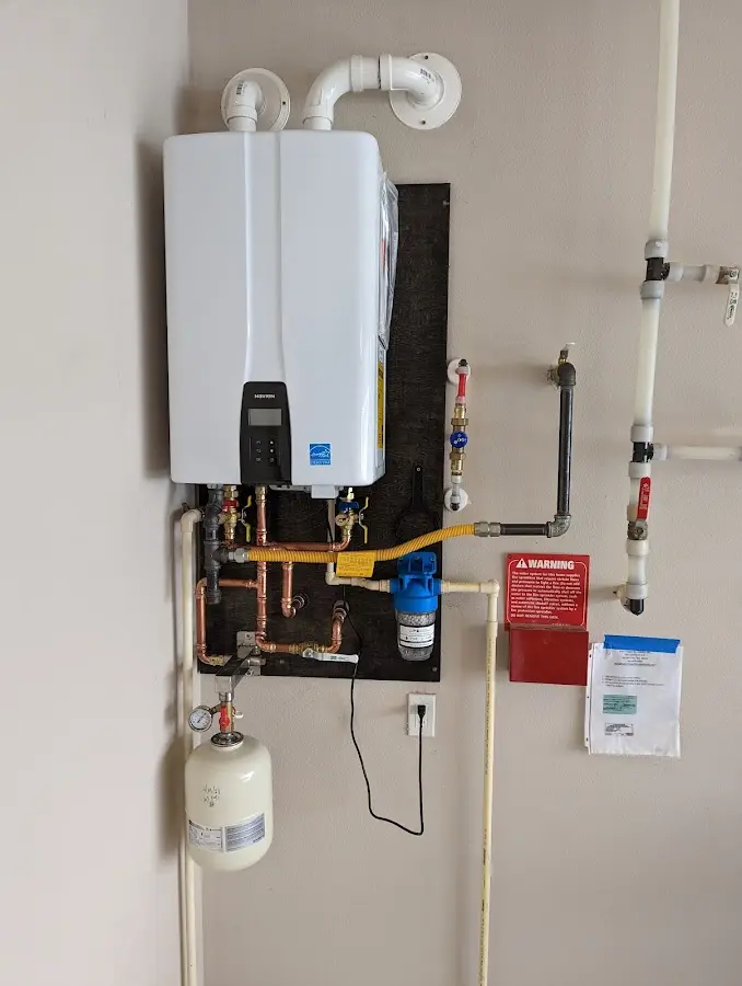 Professional plumber installing copper piping in a Redding home